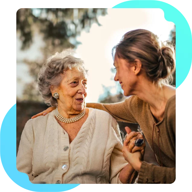 A woman providing care to an elderly woman who needs assistance with daily living activities