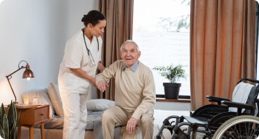 A nurse caring for an elderly man who needs daily assistance