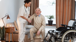 A nurse caring for an elderly man who needs daily assistance