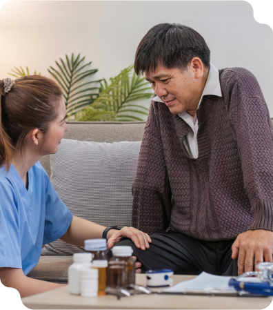 A nurse caring for an elderly man who needs daily assistance with his medications