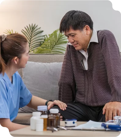 A nurse caring for an elderly man who needs daily assistance with his medications