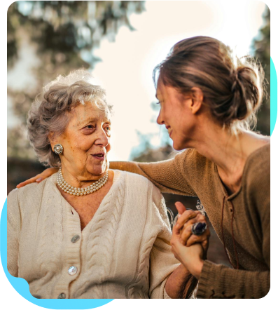 A woman caring for an elderly woman who needs daily assistance